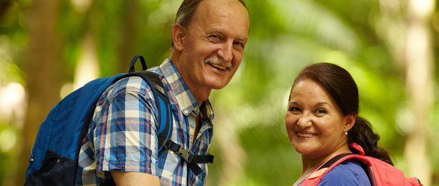 Active couple holding an apple